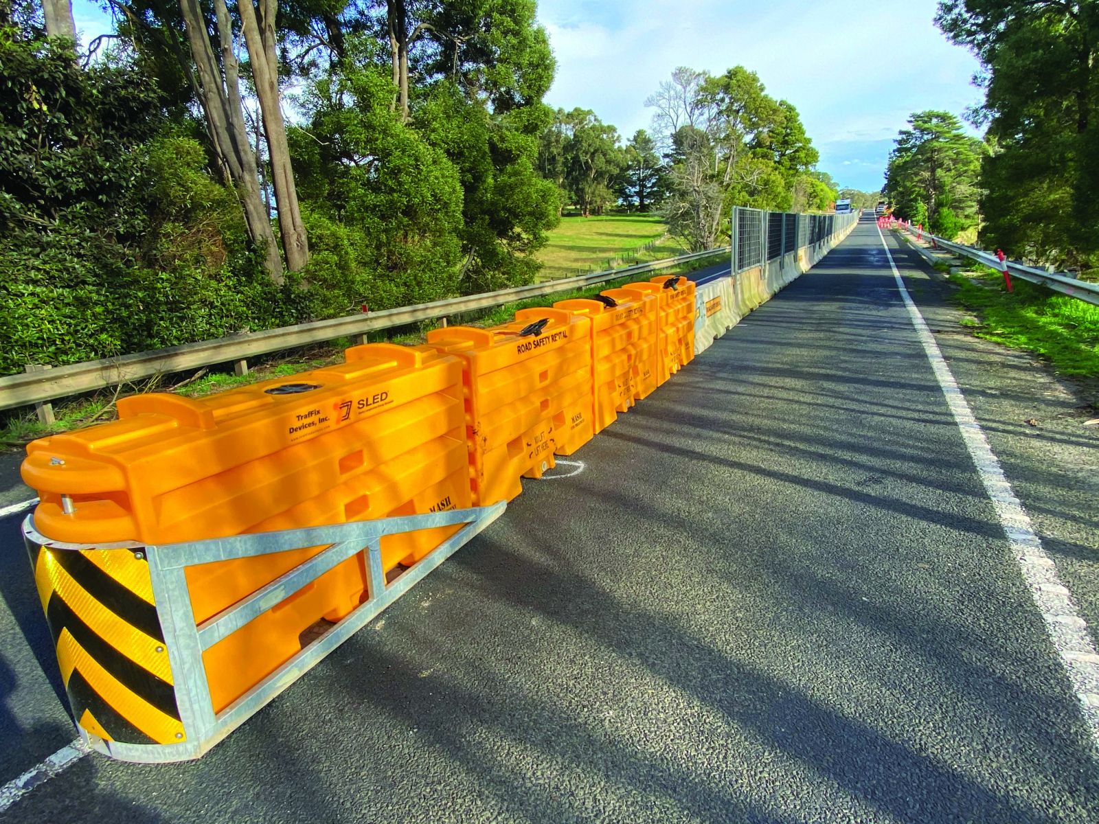 men discussing in front of barriers